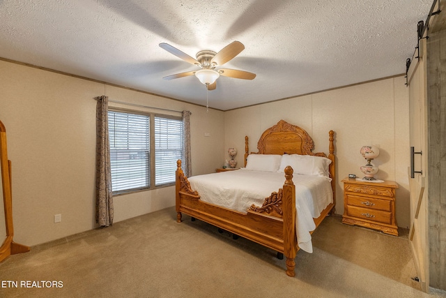 carpeted bedroom with ceiling fan and a textured ceiling