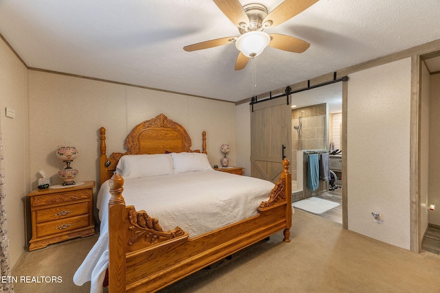 bedroom with a barn door, ceiling fan, carpet, and a textured ceiling