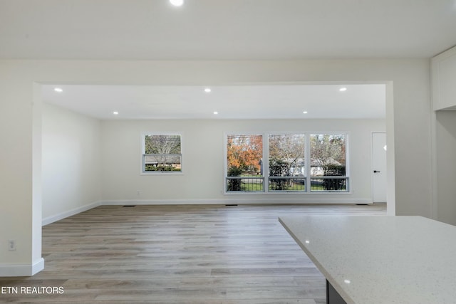 unfurnished living room featuring light hardwood / wood-style floors and a wealth of natural light