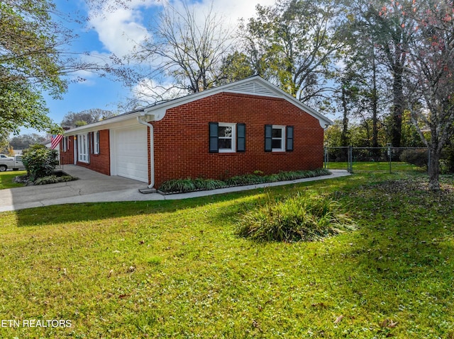 view of side of home with a garage and a yard