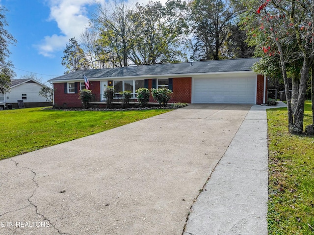 ranch-style home with a garage and a front lawn