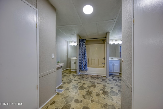 bathroom with shower / tub combo with curtain and sink