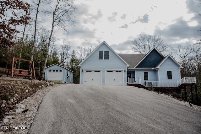 view of front facade featuring a garage and an outdoor structure