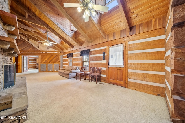 living room featuring carpet flooring, lofted ceiling with beams, ceiling fan, and wooden walls