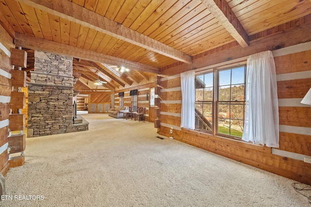 unfurnished living room featuring carpet, ceiling fan, wood walls, and wood ceiling