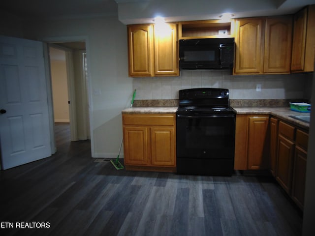 kitchen featuring tasteful backsplash, dark hardwood / wood-style flooring, and black appliances