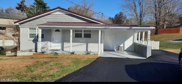 bungalow-style house with a front yard and a carport