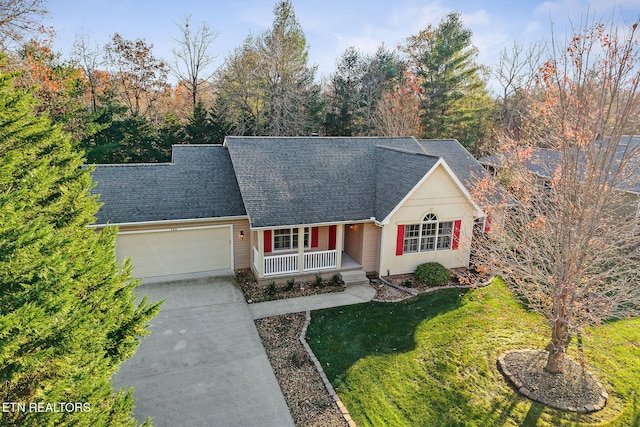 view of front facade featuring covered porch, a garage, and a front lawn