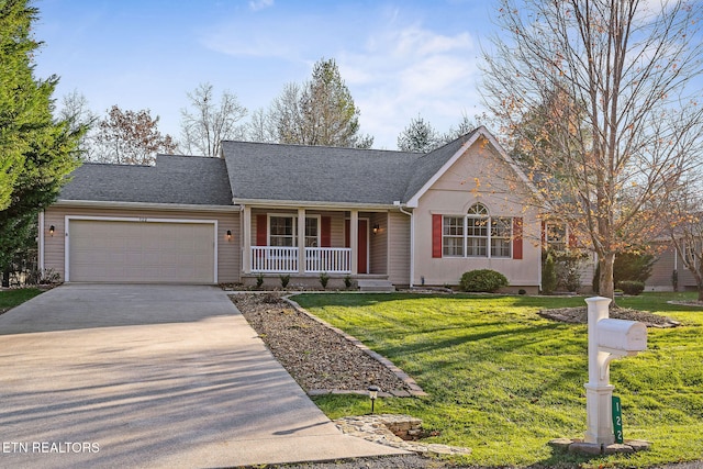 ranch-style house with covered porch, a garage, and a front lawn