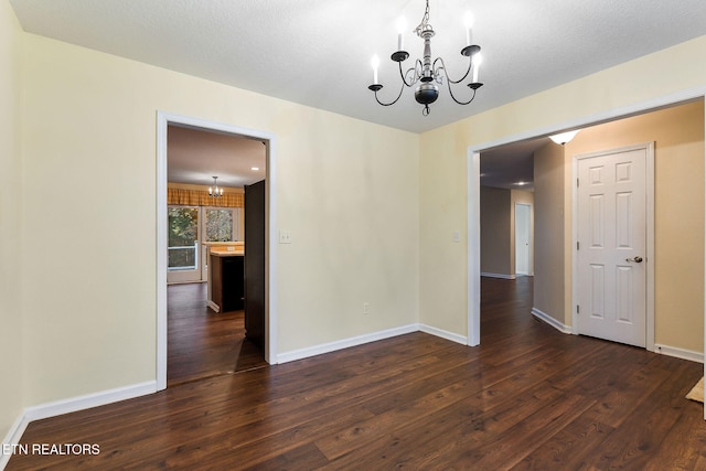 122 Windsor Rd, Crossville, TN 38558 - unfurnished dining area with a chandelier, a textured ceiling, and dark wood-type flooring