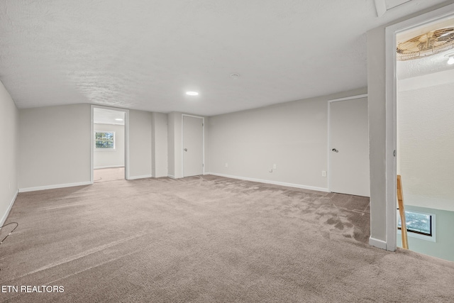 basement with carpet flooring and a textured ceiling