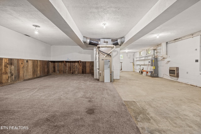 basement with gas water heater, a textured ceiling, and heating unit