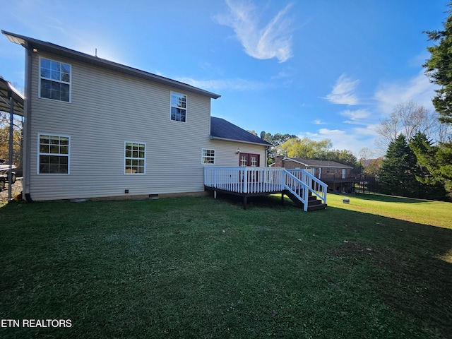 back of property with a yard and a deck