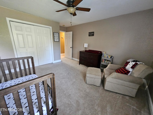 carpeted bedroom with ceiling fan and a closet