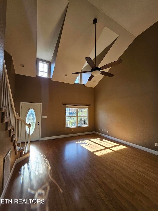 interior space featuring ceiling fan, wood-type flooring, and high vaulted ceiling