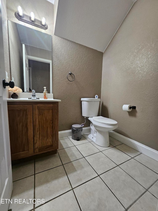 bathroom with tile patterned flooring, vanity, and toilet