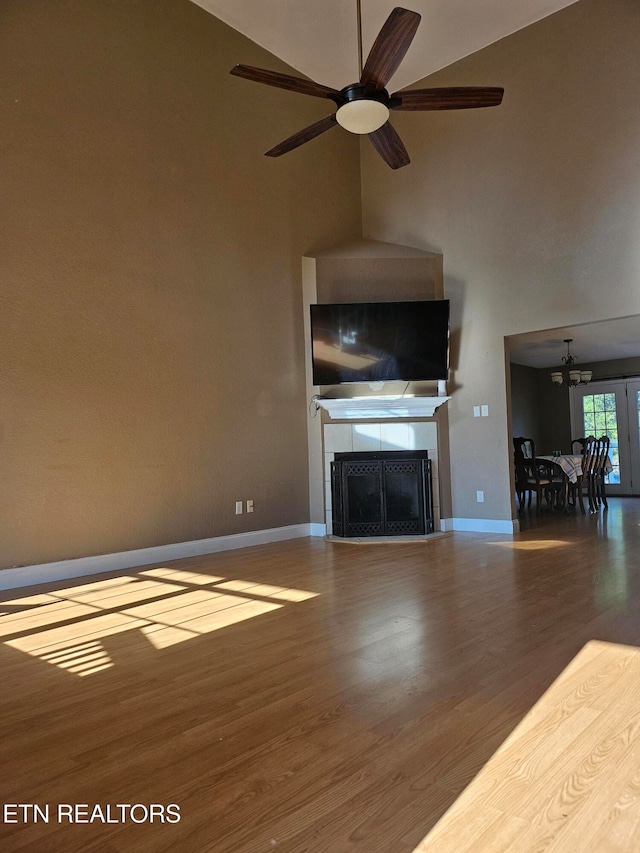 unfurnished living room featuring a fireplace, hardwood / wood-style floors, and ceiling fan