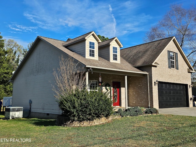 view of front of house with a front lawn, cooling unit, and a garage