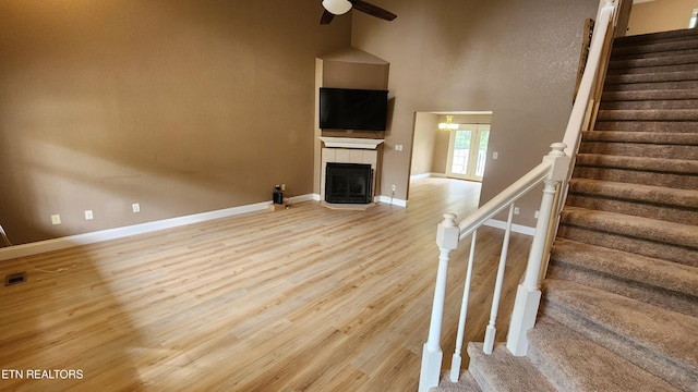 630 Chris Haven Dr, Seymour, TN 37865 - unfurnished living room featuring ceiling fan, a fireplace, baseboards, stairway, and wood finished floors
