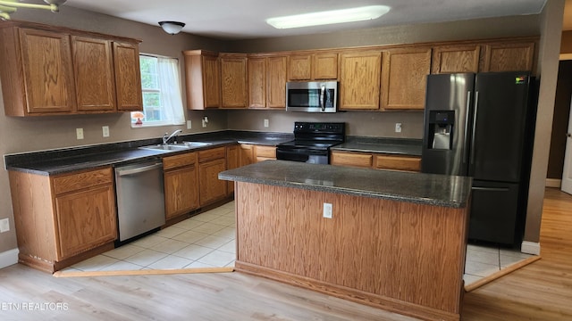 630 Chris Haven Dr, Seymour, TN 37865 - kitchen featuring black appliances, a sink, dark countertops, a center island, and brown cabinets