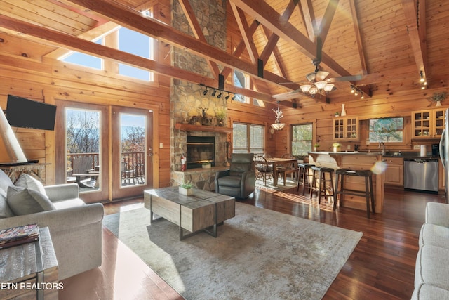 living room featuring plenty of natural light, dark hardwood / wood-style floors, and high vaulted ceiling