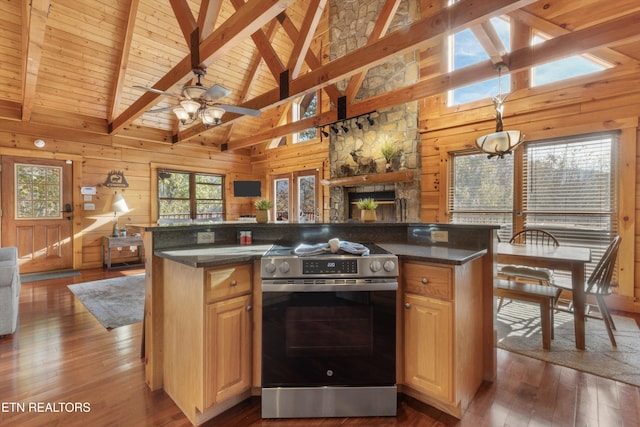 kitchen featuring a center island, dark wood-type flooring, wooden walls, stainless steel electric range oven, and beam ceiling