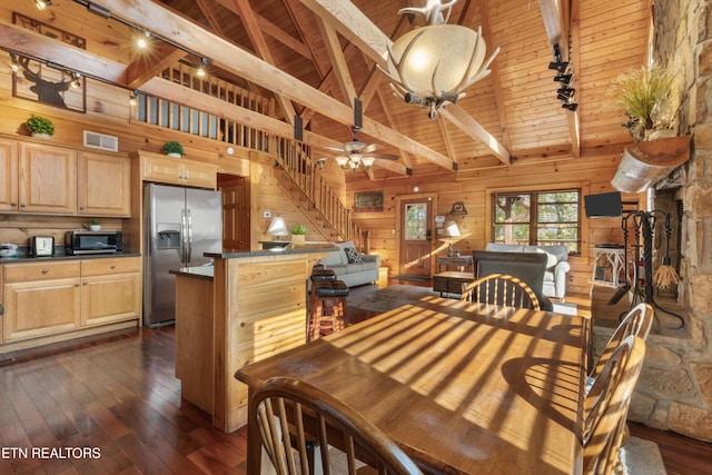 dining area featuring beam ceiling, wooden walls, high vaulted ceiling, and dark wood-type flooring