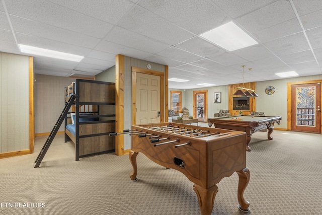 playroom with a paneled ceiling, wood walls, light carpet, and billiards