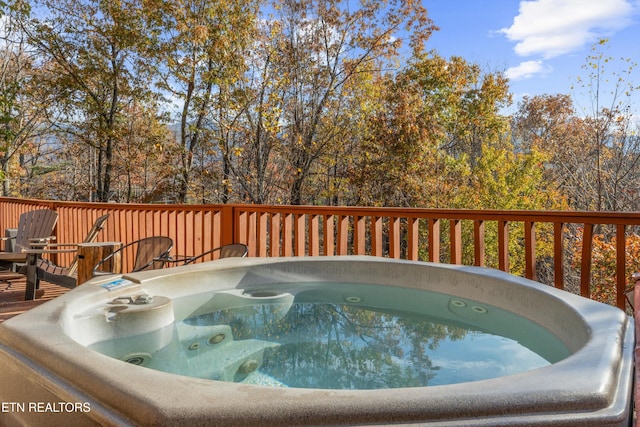 wooden terrace featuring a hot tub