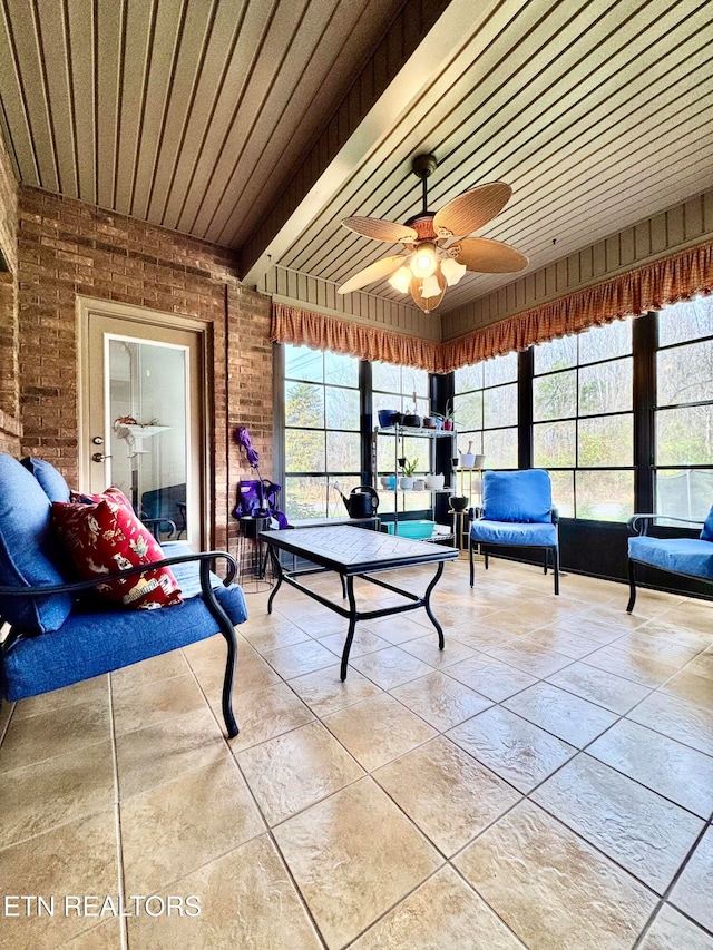 unfurnished sunroom with ceiling fan and wood ceiling