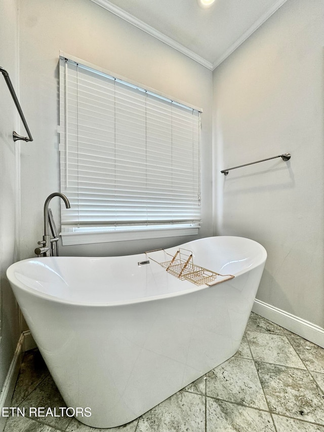 bathroom with a bath and crown molding