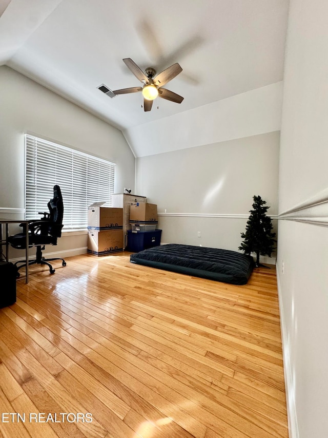 office space featuring light hardwood / wood-style floors, vaulted ceiling, and ceiling fan