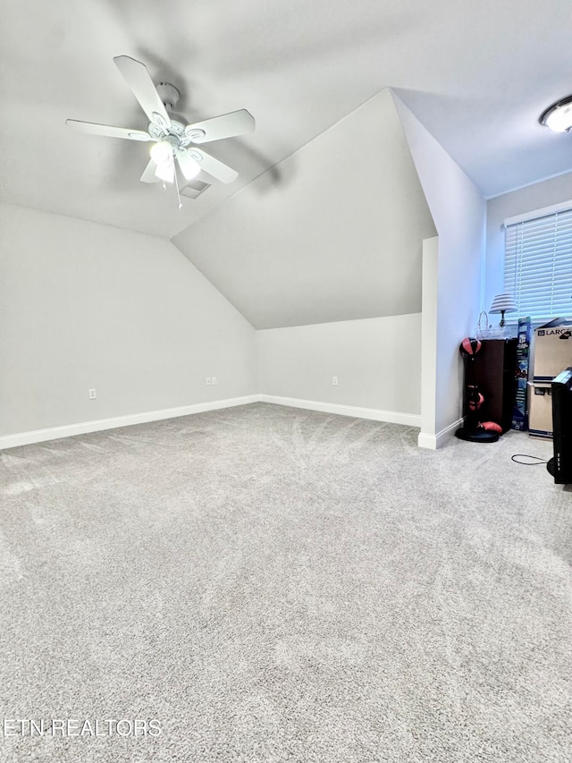 bonus room featuring ceiling fan, carpet floors, and vaulted ceiling