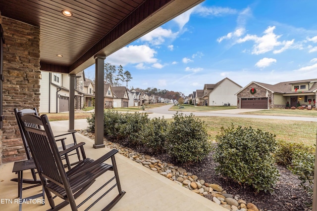 view of patio featuring covered porch and a garage