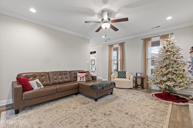 living room featuring crown molding, ceiling fan, and wood-type flooring