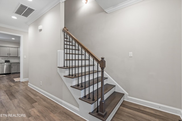 stairway featuring hardwood / wood-style floors and ornamental molding