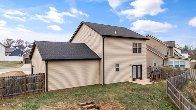 back of house featuring a yard and a patio