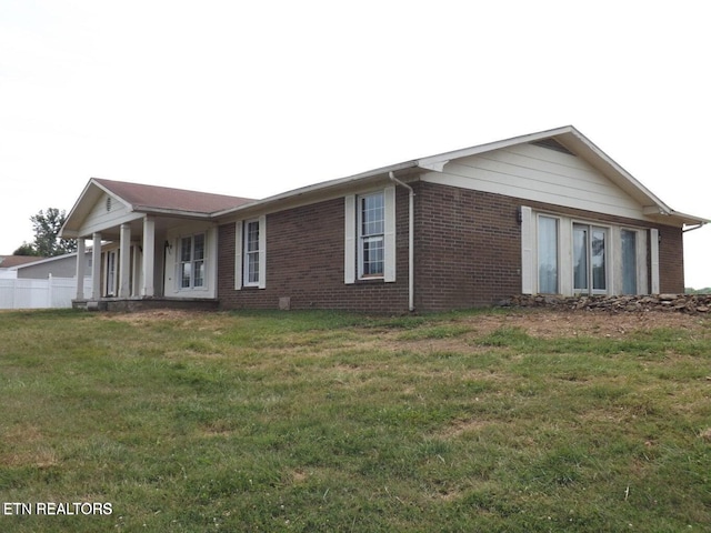 exterior space with a front yard and brick siding