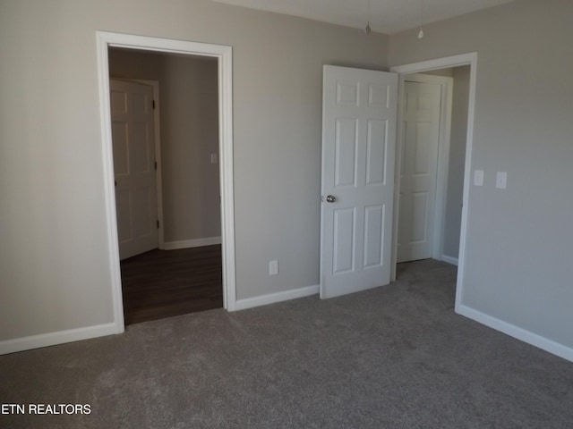 unfurnished bedroom featuring baseboards and carpet floors