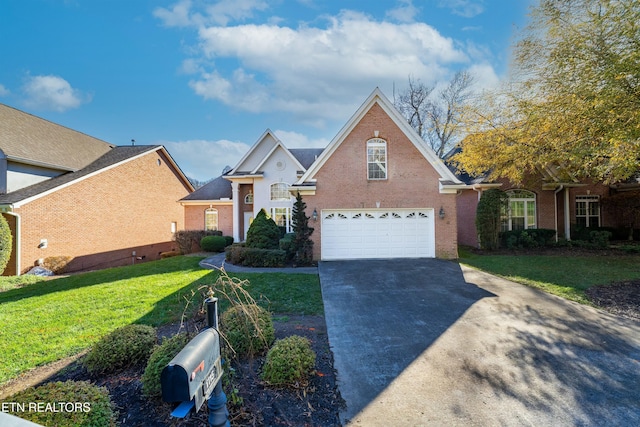 view of property with a garage and a front lawn