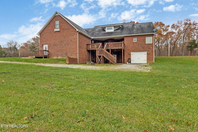 back of house with a lawn, a garage, and a deck