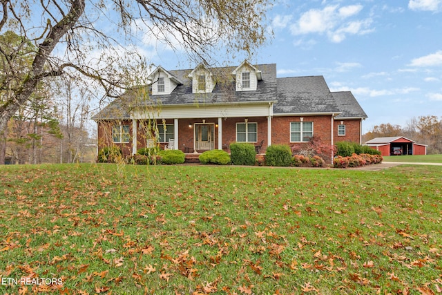 cape cod house with a front yard