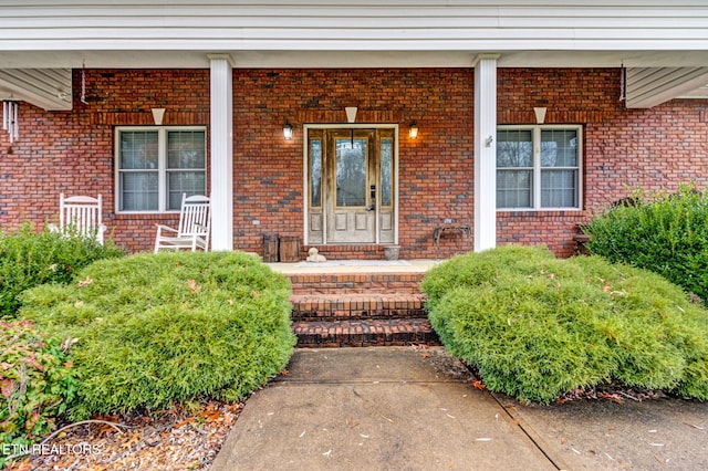 view of exterior entry with a porch