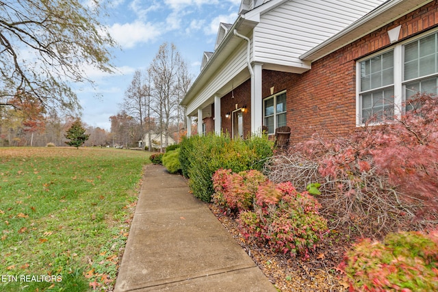 view of side of property with a yard