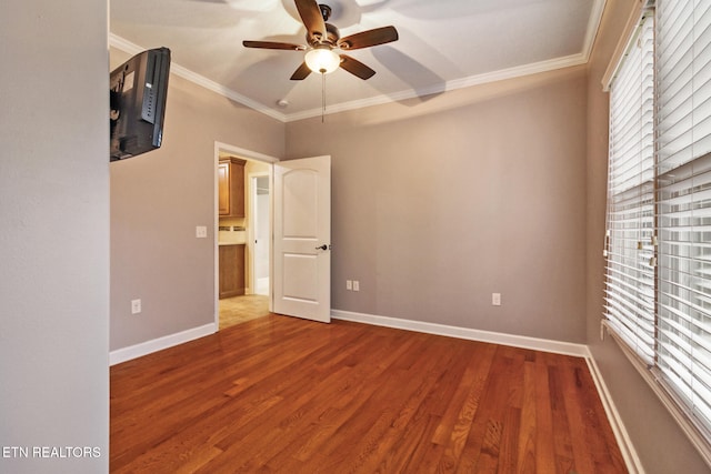 unfurnished room featuring ceiling fan, wood-type flooring, and ornamental molding