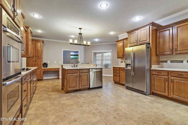 kitchen with appliances with stainless steel finishes, sink, pendant lighting, a center island with sink, and a chandelier