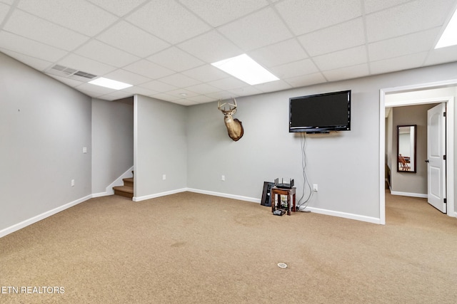 basement featuring carpet floors and a paneled ceiling