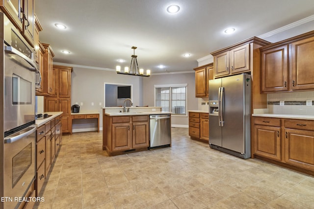 kitchen featuring a center island with sink, sink, appliances with stainless steel finishes, decorative light fixtures, and a chandelier