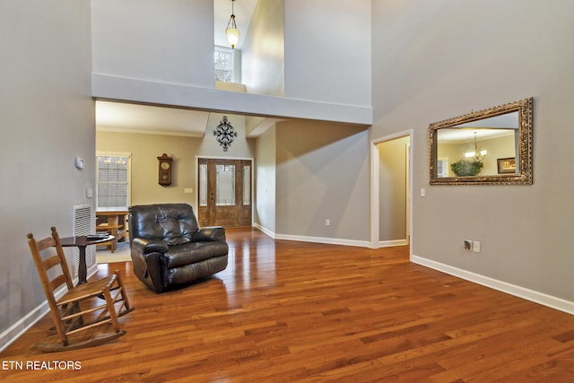 interior space with a high ceiling and hardwood / wood-style flooring