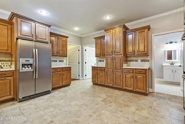 kitchen with stainless steel refrigerator with ice dispenser, tasteful backsplash, ornamental molding, sink, and light tile patterned floors